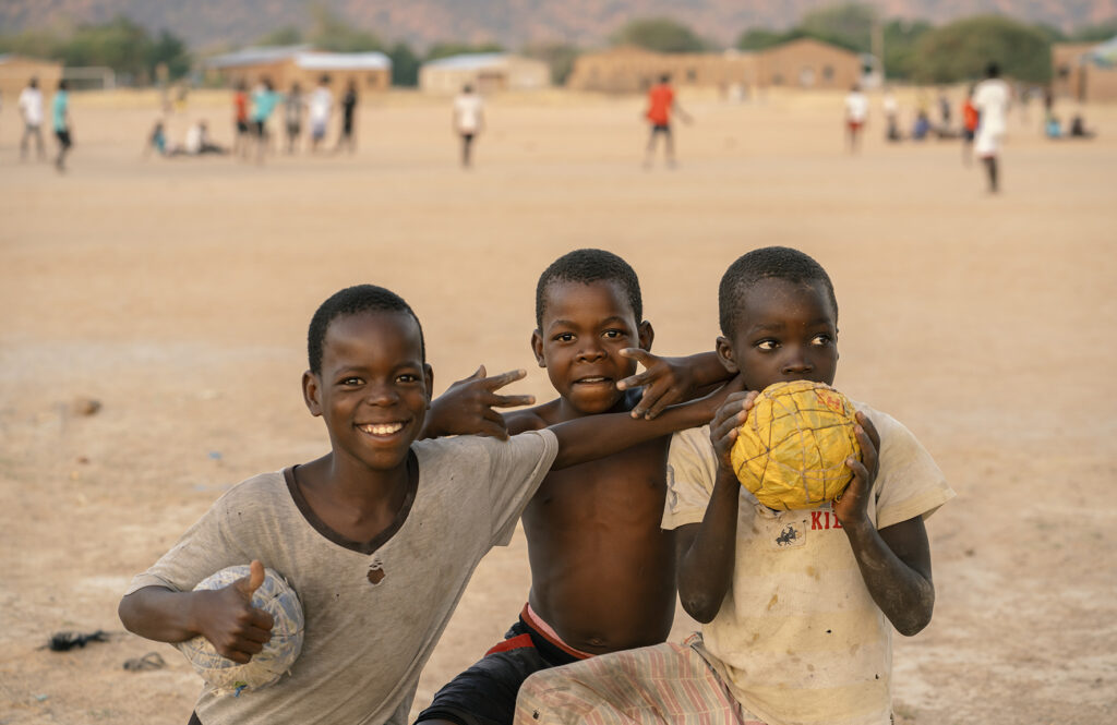 african kids playing with improvised ball 