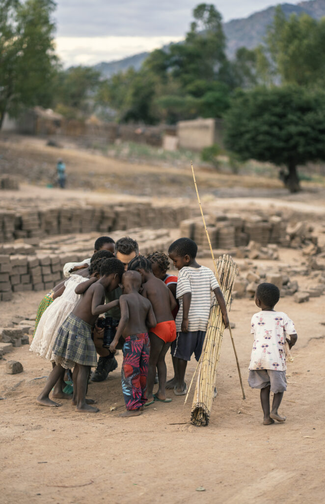 white photographer among black african kids 