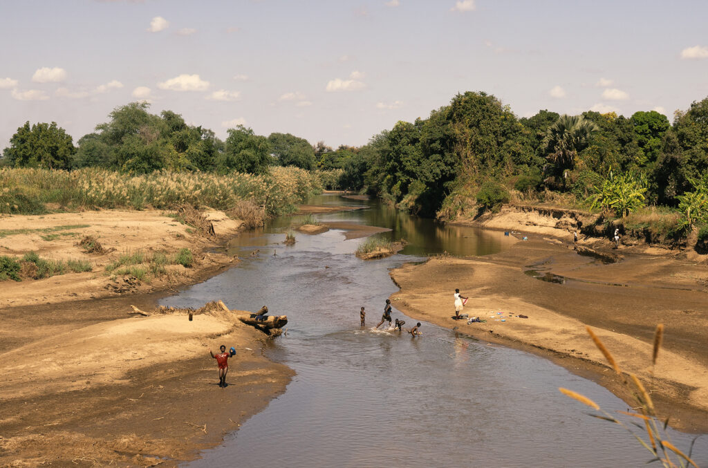 zambian people washing in river 