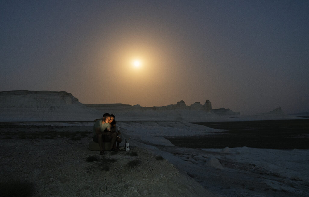couple camping under moonlight 